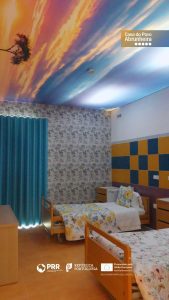 lar para idosos apoiados pela segurança social com duas camas e teto com tela de uma árvore com o pôr do sol bonito